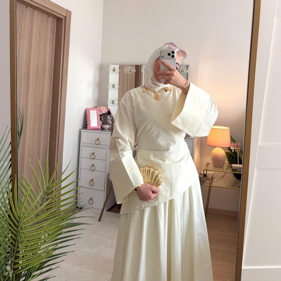 Asymmetric hem detail on fitted modest top