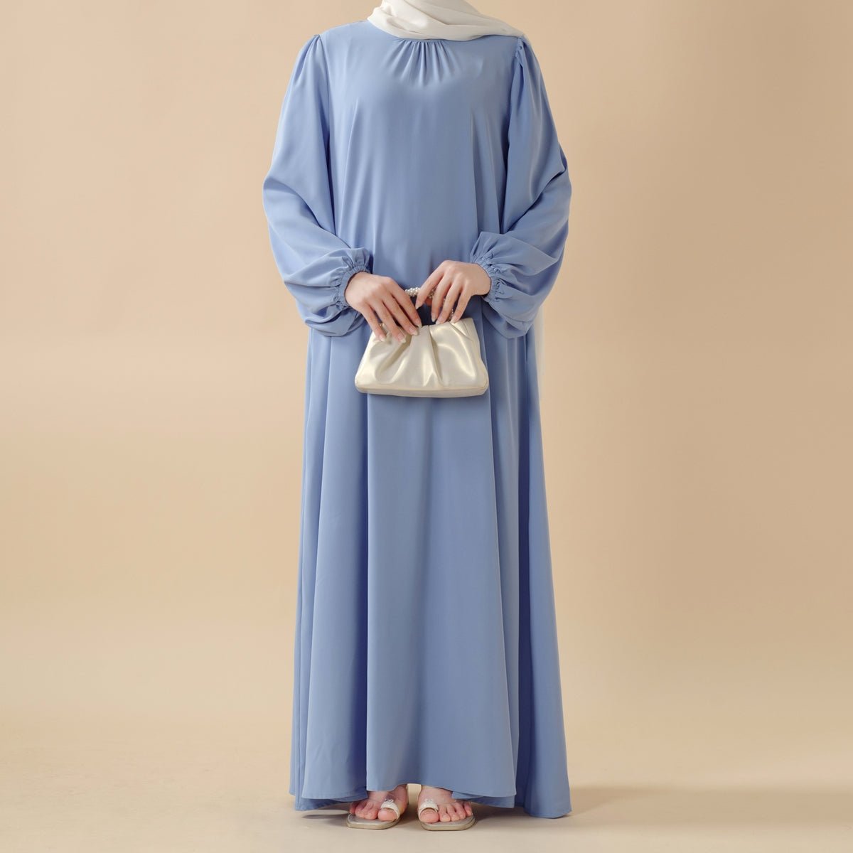 Candy pastel abaya styled with matching belt for structured silhouette