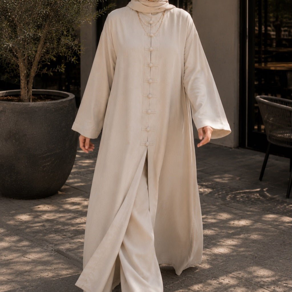 Close-up of hand-knotted tonal frog button placket on sand camel robe