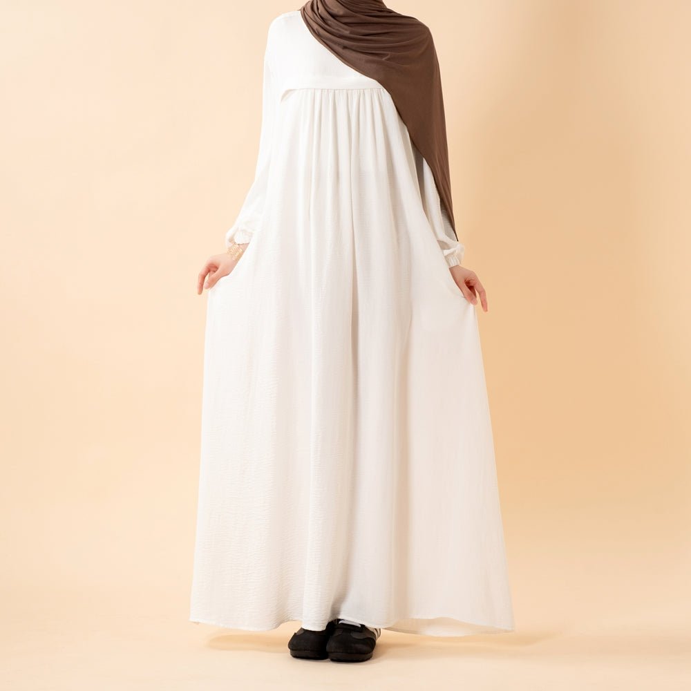 Model wearing lightweight breathable Umrah abaya outdoors