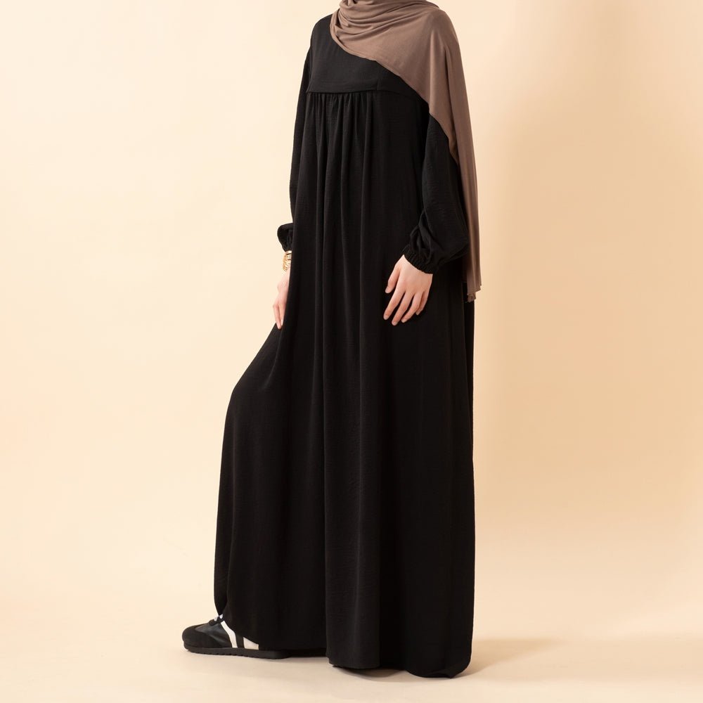 Full-length view of white Umrah abaya in natural light