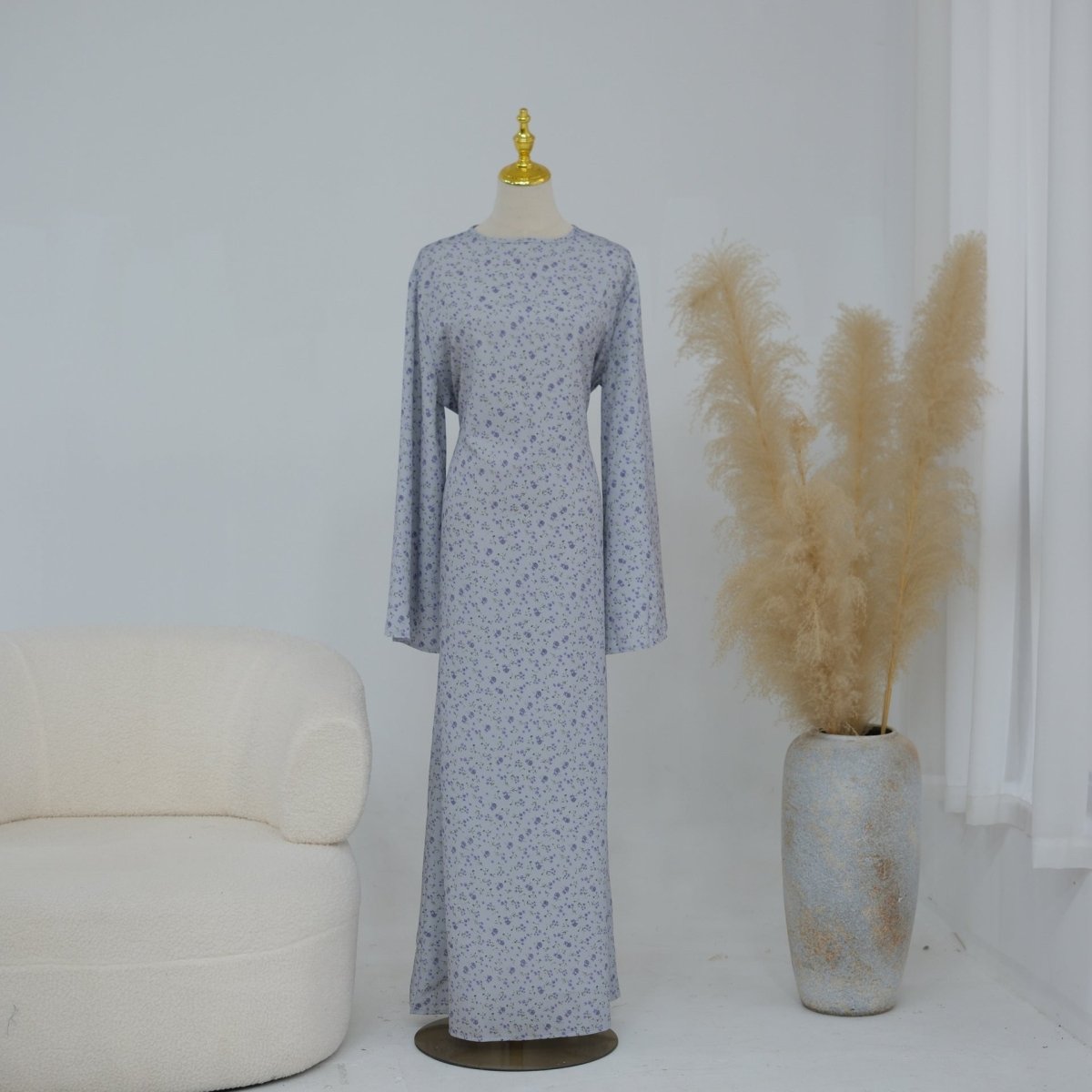 Angled view of modest floral maxi dress showing belt and neckline