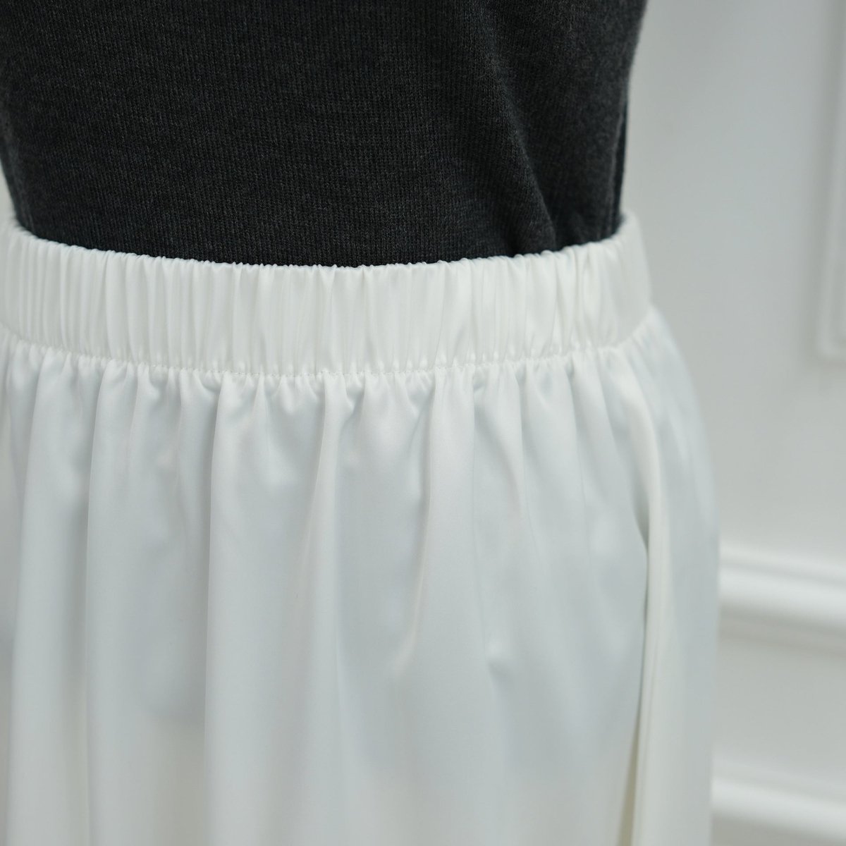Relaxed waist ribbon styling on satin top for flowing silhouette