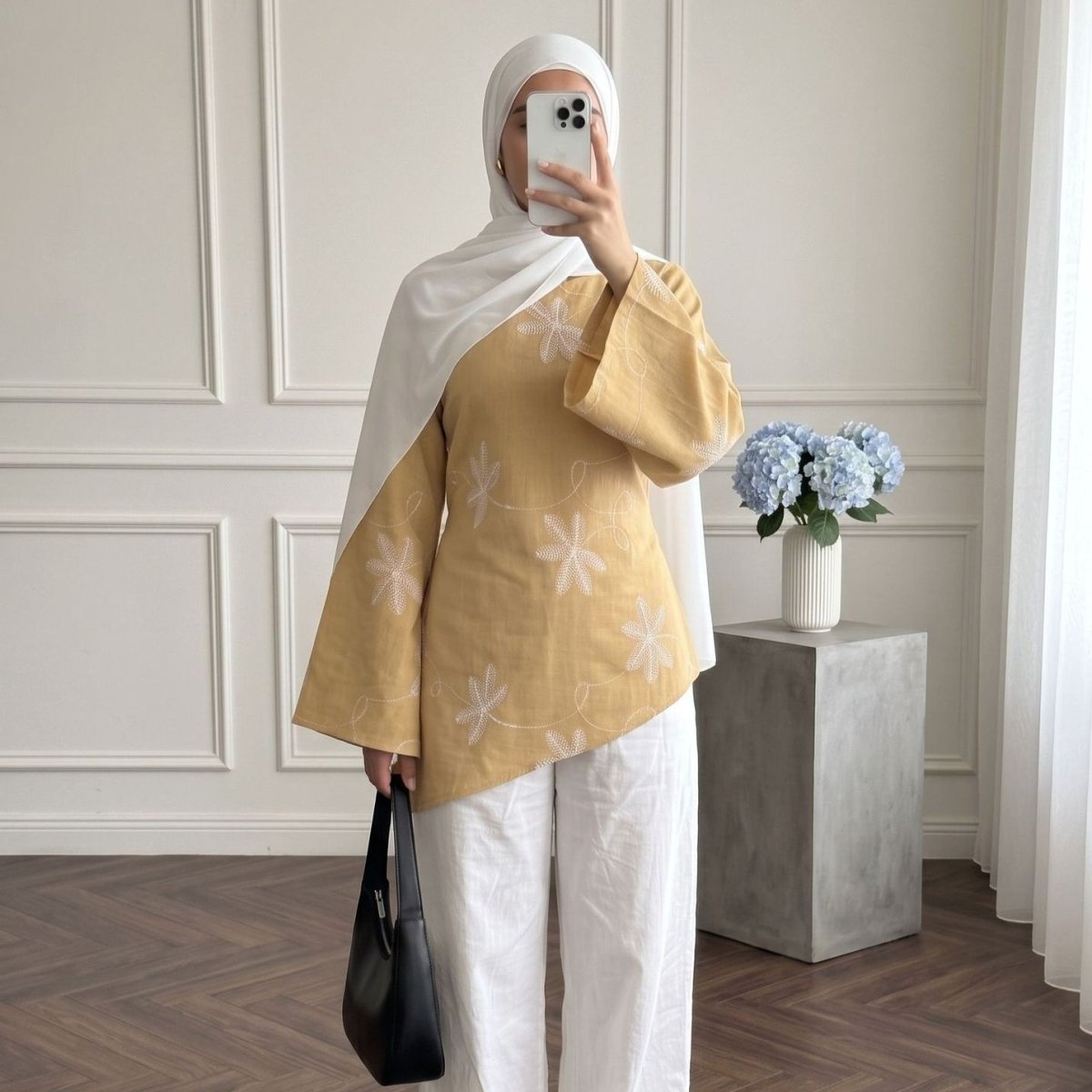 Three-quarter view of structured matte-finish fabric with all-over floral embroidery