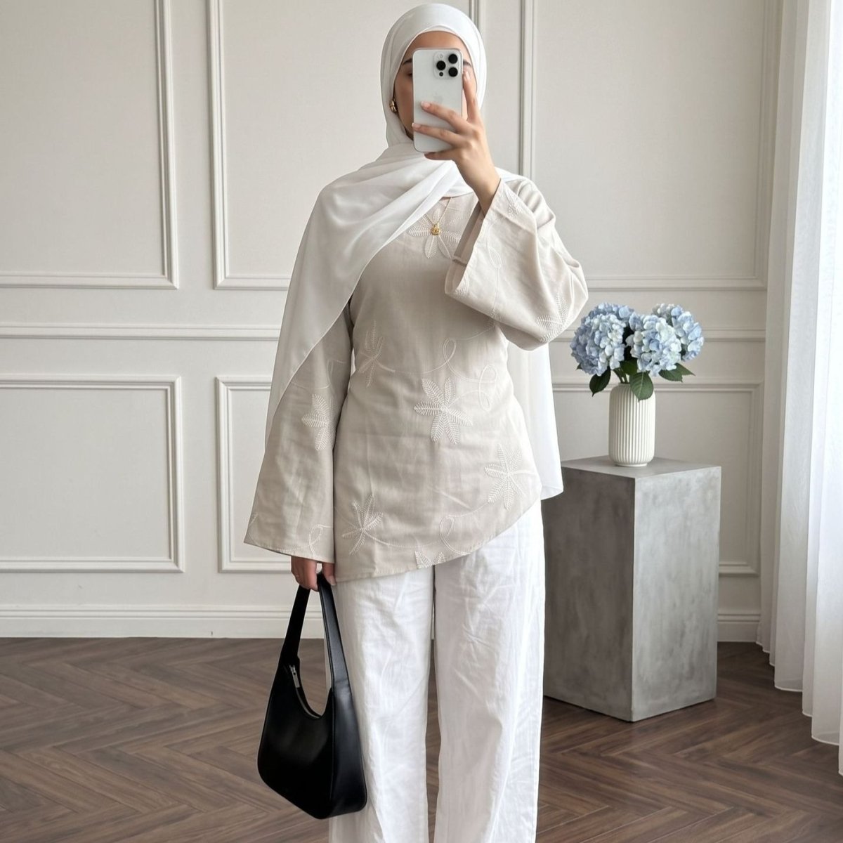 Styled outfit view of leaf floral embroidered top with modest layering