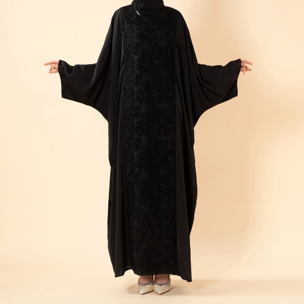 Snap cuff detail on wide batwing sleeve of embroidered satin abaya
