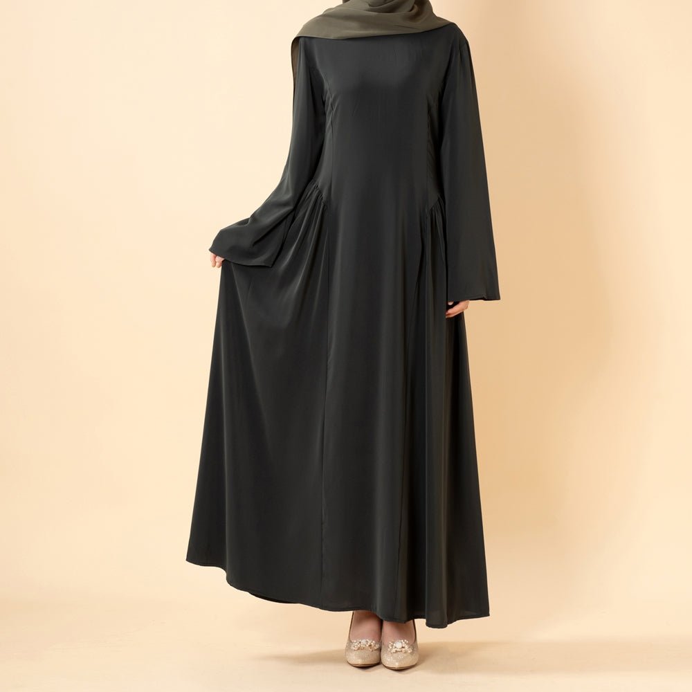 Three-quarter view of the pleated A-line nida abaya