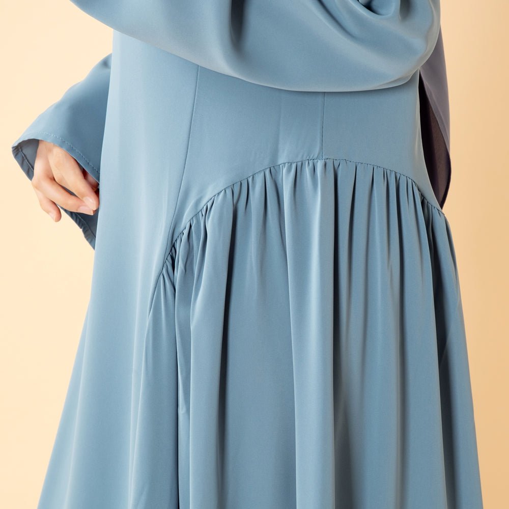 Standing pose showing full flared nida abaya drape