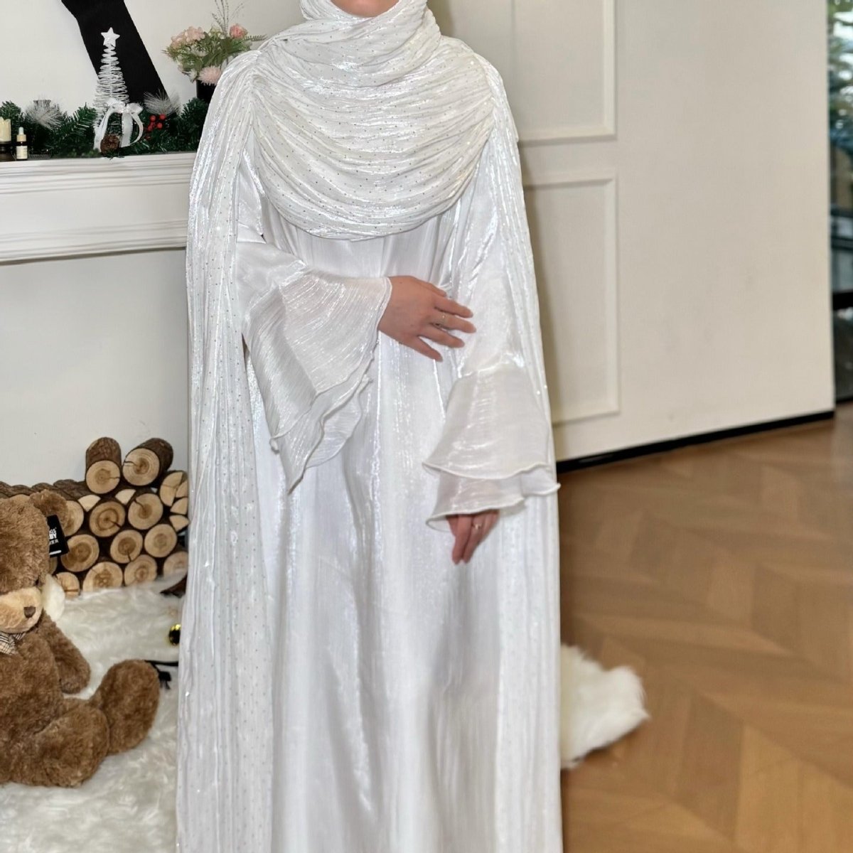Floor-length view of rhinestone silk abaya with cape sleeves in motion