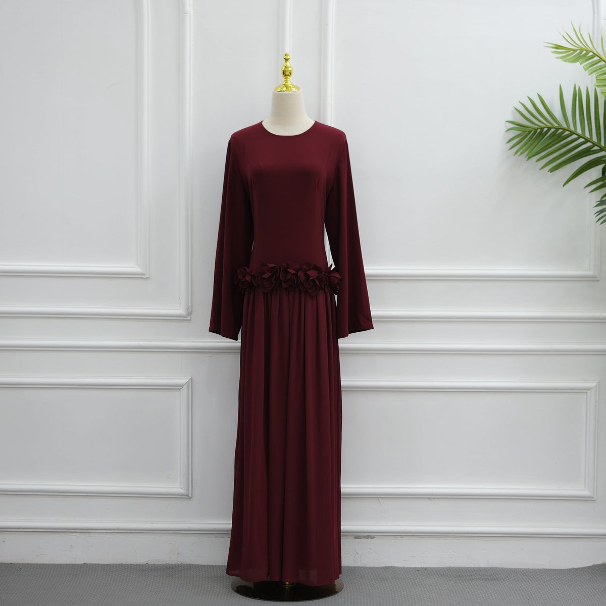 Full-length side profile of burgundy 3D rose maxi dress