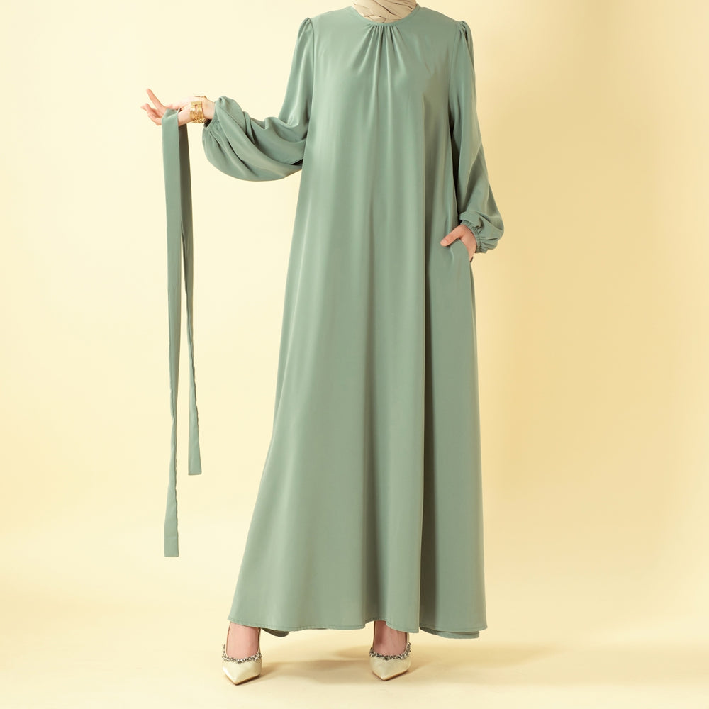 Pleated abaya with elastic cuff sleeves — front detail view