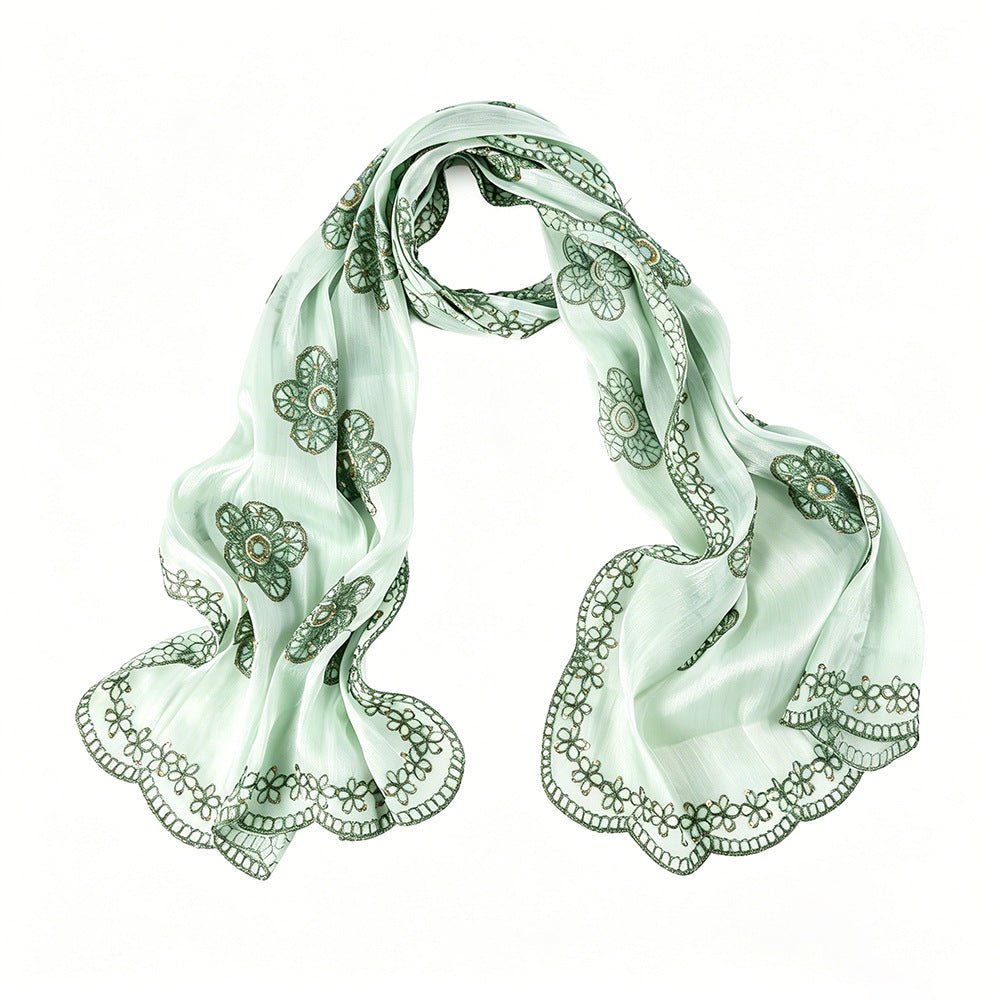 Overhead flat lay of full-length floral embroidered maxi hijab scarf