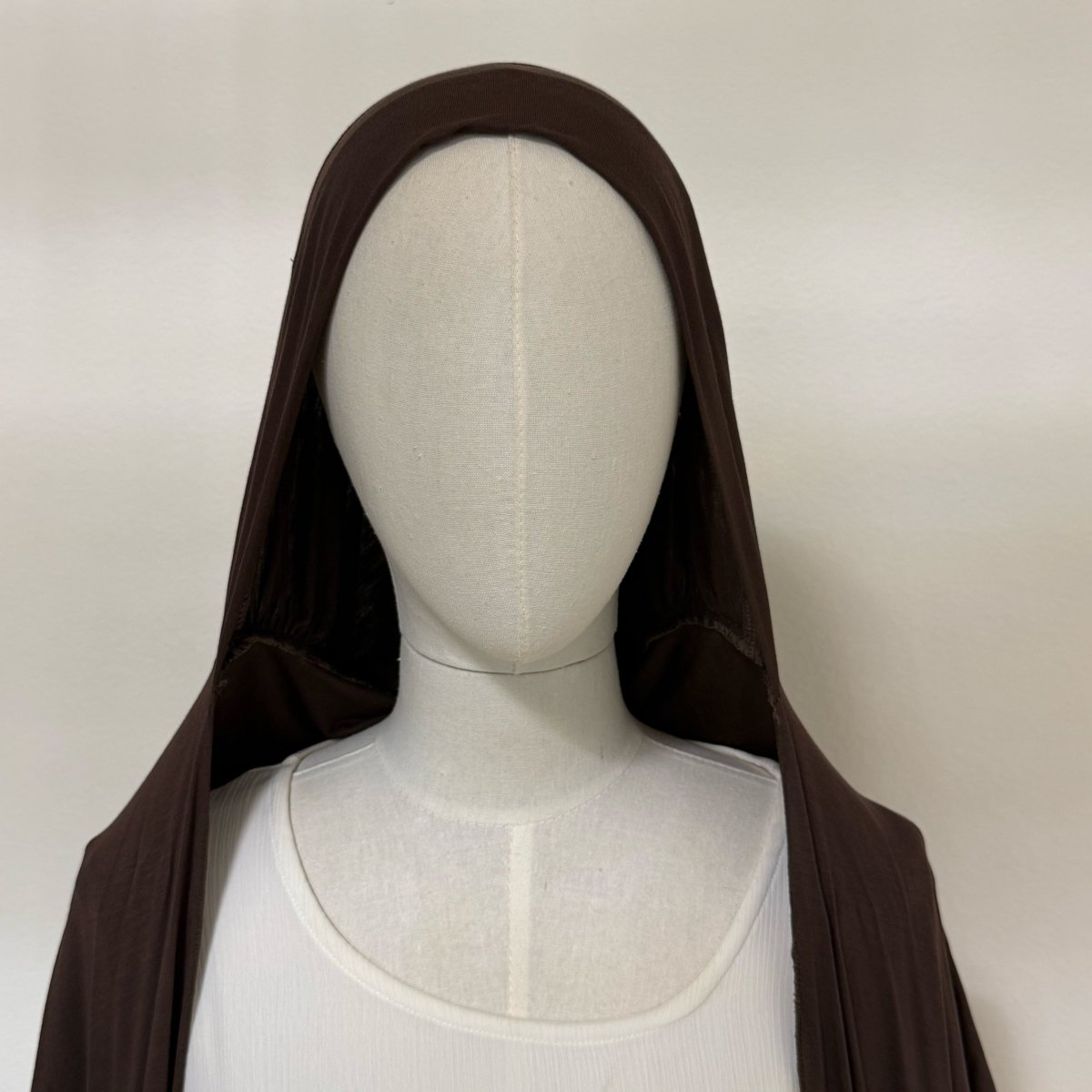 Earphone-friendly hijab liner shown with earphones in ear