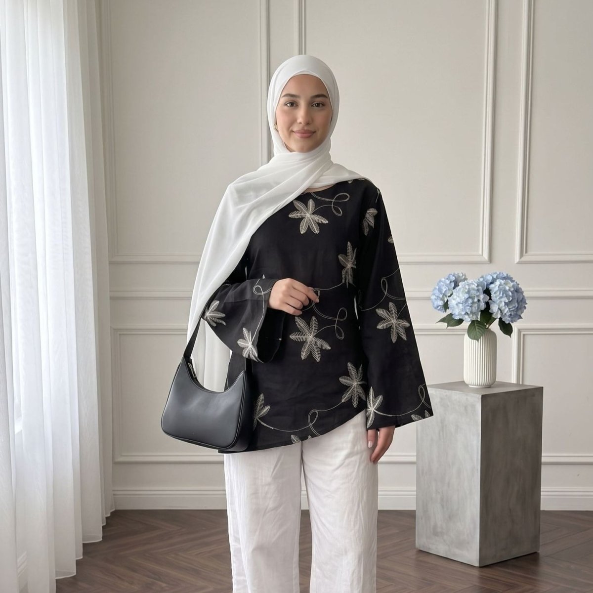 Side profile showing relaxed straight silhouette and asymmetric hem cut