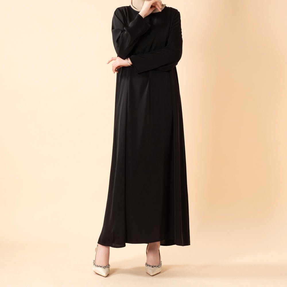 Close-up of round neckline and long sleeve cuff on satin inner dress