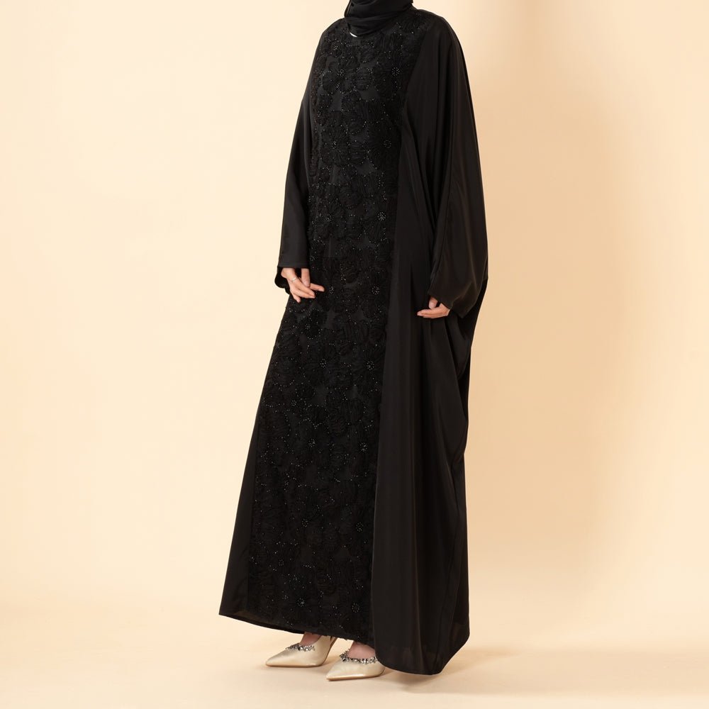 Side profile of luxury batwing abaya showing graceful drape and movement