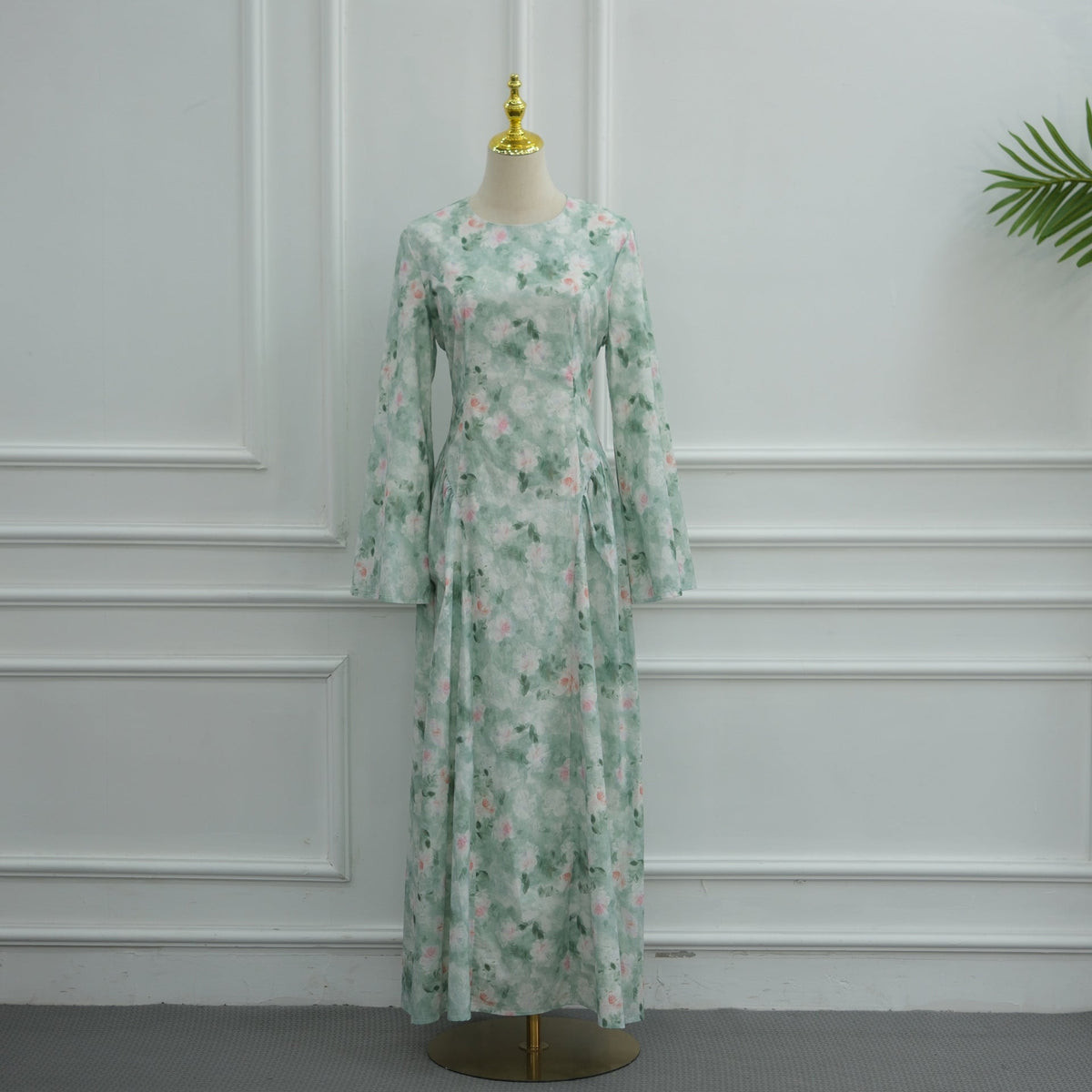 Close-up of botanical floral print bleeding colour edges on maxi dress fabric